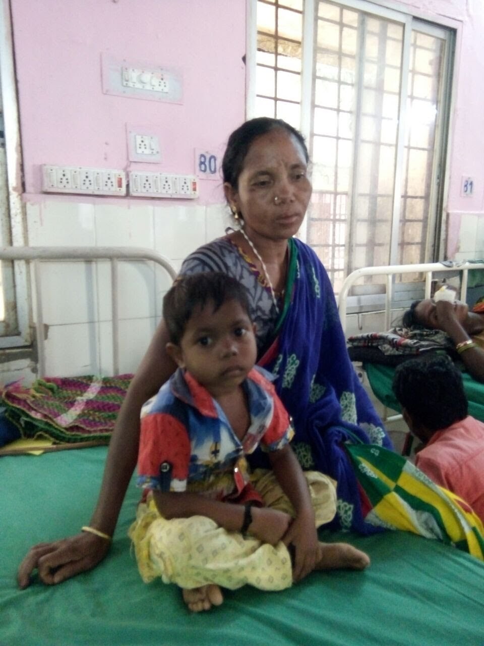 A single mother tending to her seriously ill child born without a rectum