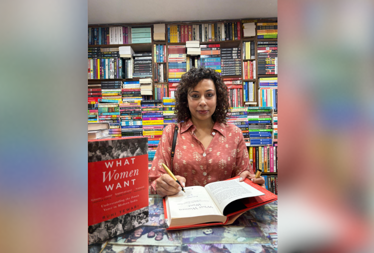 A photograph of author Ruhi Tewari signing her book at a bookstore