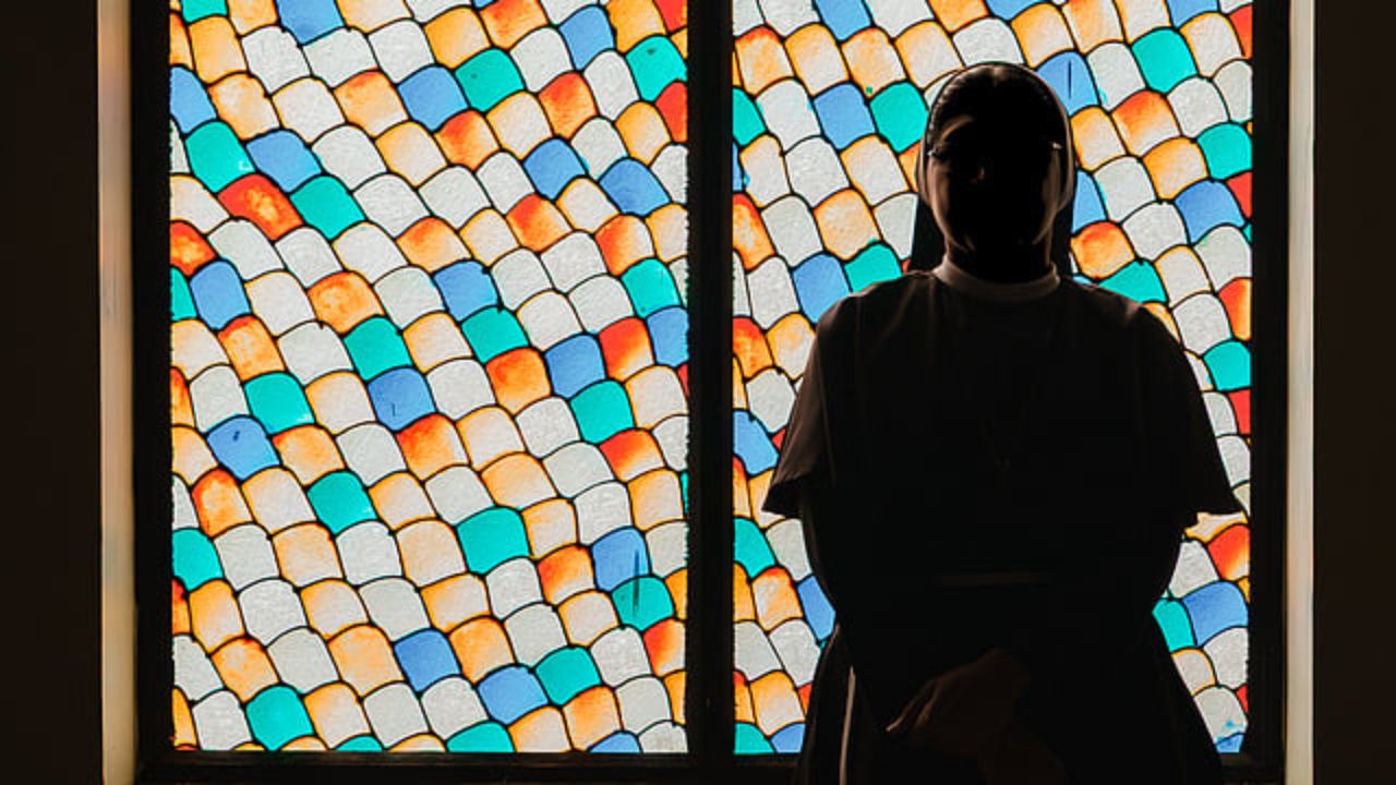 The survivor sister in the Bishop Franco case seen next a stainglass window.
