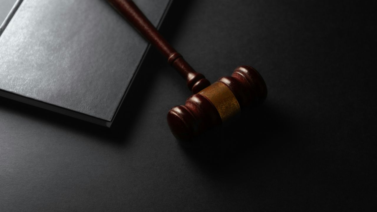 Photo of a judge's hammer and a book